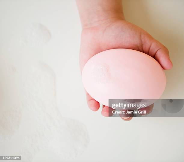 usa, new jersey, jersey city, close up of girl's (8-9) hand holding soap bar - pink jersey bildbanksfoton och bilder