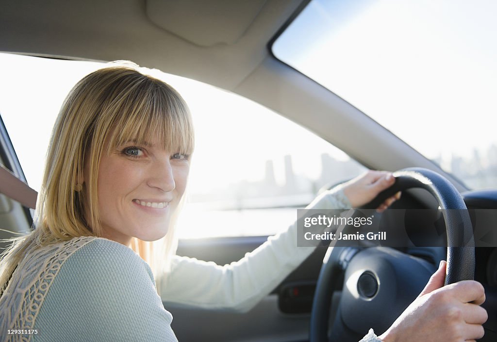 USA, Brooklyn, Williamsburg, Portrait of blonde woman driving car