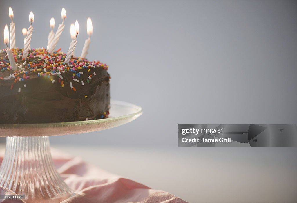 Close up of chocolate birthday cake with candles