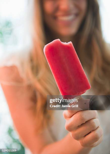 usa, new jersey, jersey city, close up of woman holding popsicle - lollies stock-fotos und bilder