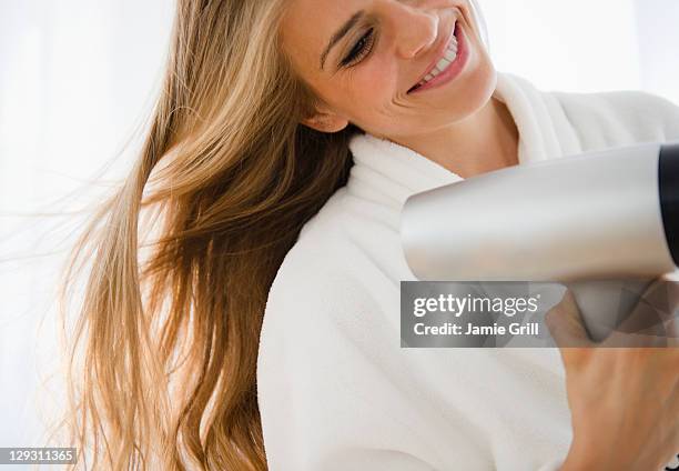 usa, new jersey, jersey city, woman drying hair - haartrockner stock-fotos und bilder