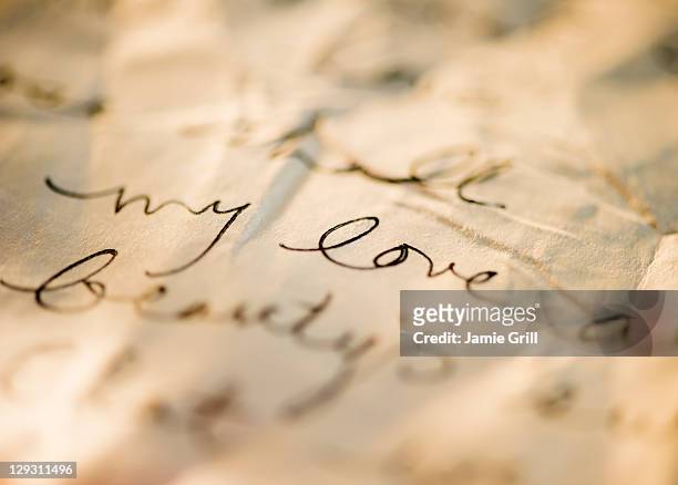 close up of antique love letter on parchment  - love letter stock-fotos und bilder