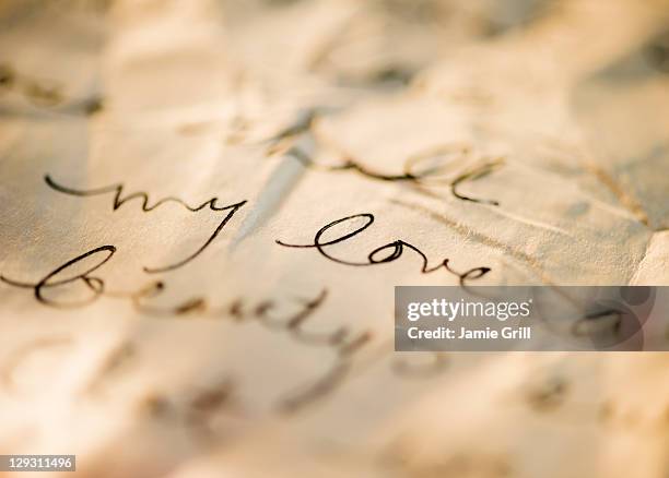 close up of antique love letter on parchment - carta de amor fotografías e imágenes de stock