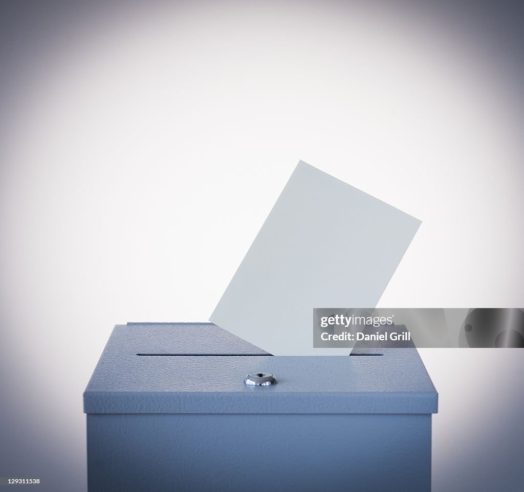 Ballot box and blank paper, studio shot