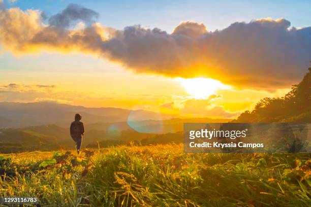 young man enjoying time in beautiful mountain landscape - nice weather stock pictures, royalty-free photos & images