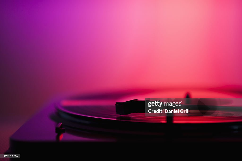 Close up of turntable on pink background