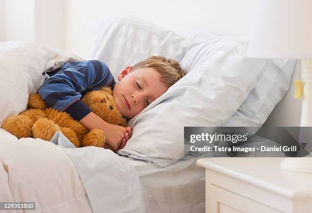 usa, new jersey, jersey city, close up of boy (4-5) sleeping in bed - boy asleep in bed stock pictures, royalty-free photos & images