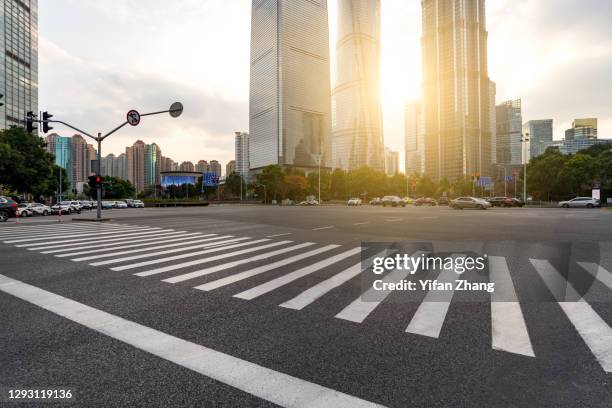 an empty intersection with zebra line in lujiazui financial district in shanghai - passage balisé photos et images de collection