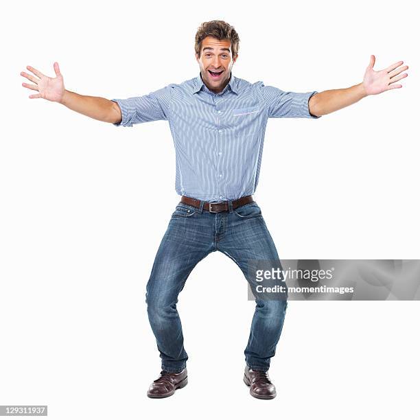 studio shot of young cheerful man with arms outstretched - arms outstretched fotografías e imágenes de stock