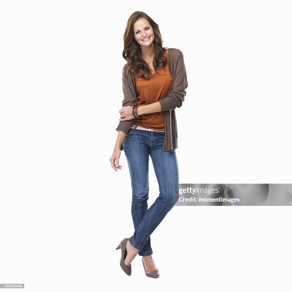 Studio shot of young attractive woman standing on white background and smiling