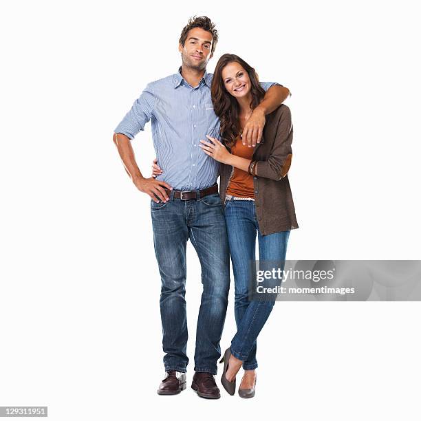 studio shot of young couple standing together on white background - couple standing stockfoto's en -beelden