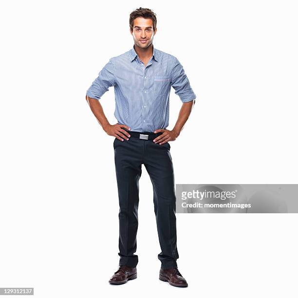 portrait of young business man standing with hands on hips and smiling against white background - formal portrait stock-fotos und bilder