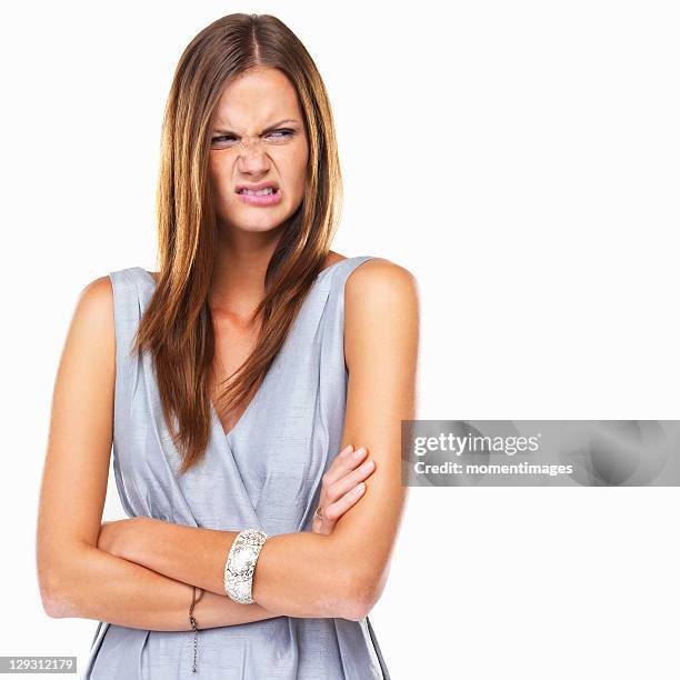 portrait of disgusted woman standing with hands folded - offensive stockfoto's en -beelden