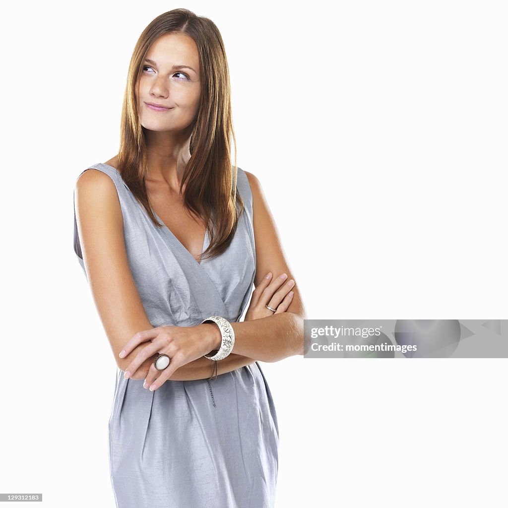 Beautiful woman smiling and looking away with hands folded