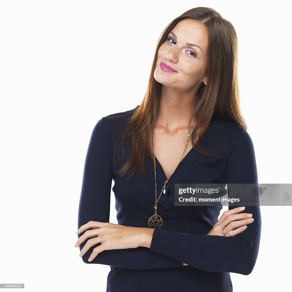 Portrait of attractive young woman standing with hands folded and smiling