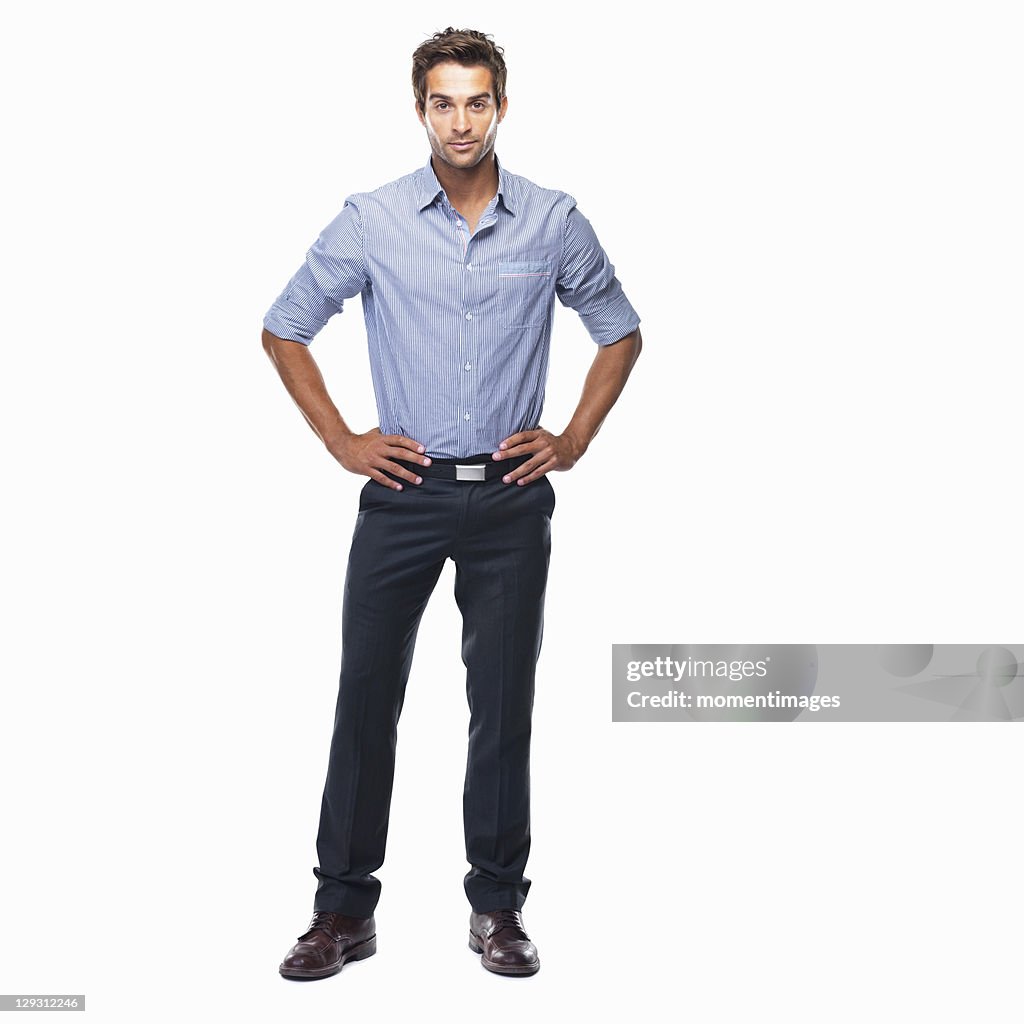 Studio shot of attractive business man standing with hands on hips