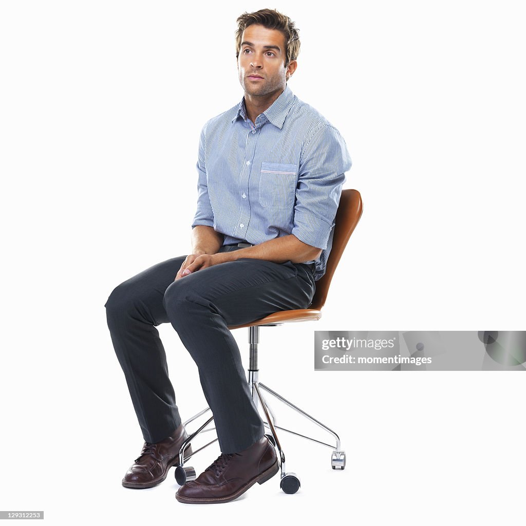 Studio shot of pensive business man sitting on chair