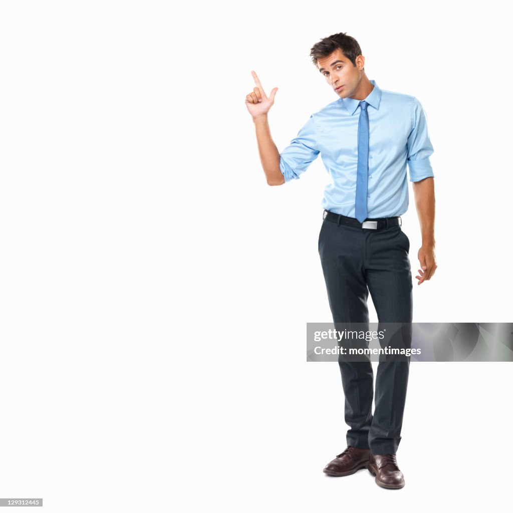 Studio shot of business man pointing upwards
