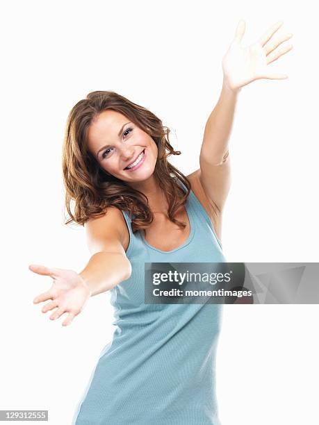 studio portrait of attractive young woman reaching hands towards camera - woman reaching hands towards camera stock pictures, royalty-free photos & images