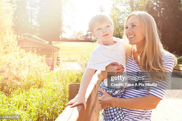 usa, washington state, seattle, young woman embracing son (2-3) in park -  "suprijono suharjoto" or "take a pix media" stock pictures, royalty-free photos & images