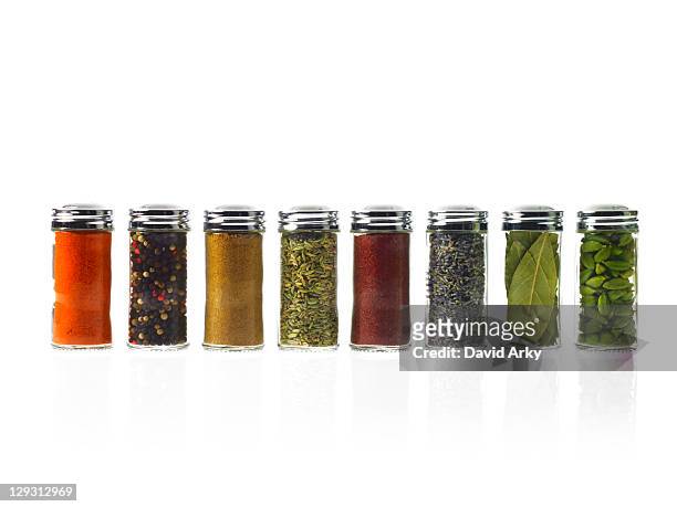 studio shot of row of jars with spices - spice stock pictures, royalty-free photos & images