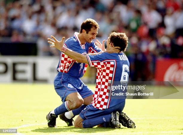 Igor Stimac of Croatia celebrates with team mate Slaven Bilic after the World Cup second round match against Romania at the Parc Lescure in Bordeaux,...