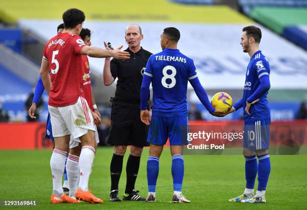 Referee, Mike Dean talks with Youri Tielemans of Leicester City and Harry Maguire of Manchester United during the Premier League match between...