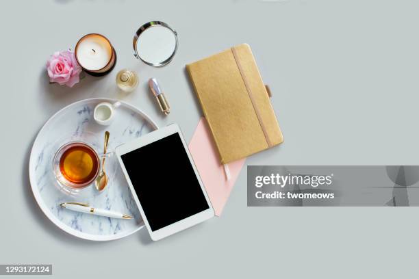 flat lay text space pastel toned feminine stylised tea break table top with empty screen digital tablet still life. - coffee table from above stock-fotos und bilder