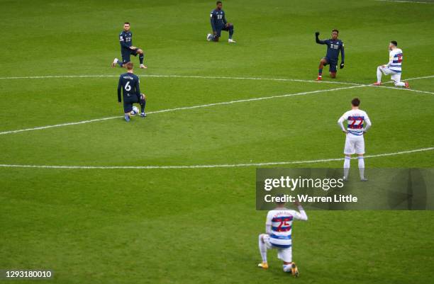 General view as Tom Carroll of Queens Park Rangers stands, whilst Swansea City and Queens Park Rangers players take a knee in support of the Black...