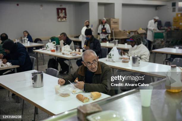 Several people eat in the soup kitchen of the parish of Carmen on Christmas Day, which can only hold 20% of its capacity due to restrictions in place...