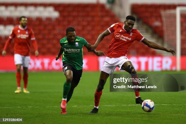Sammy Ameobi of Nottingham Forest is challenged by Jeremie Bela of Birmingham City during the Sky Bet Championship match between Nottingham Forest...