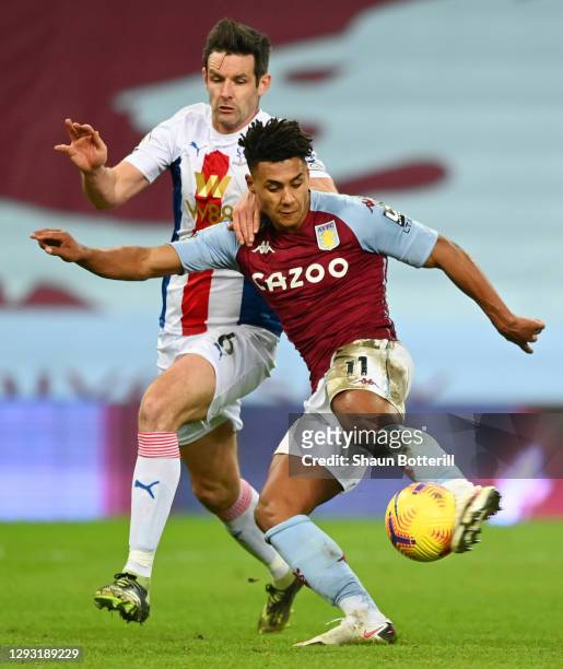 Ollie Watkins of Aston Villa is challenged by Scott Dann of Crystal Palace during the Premier League match between Aston Villa and Crystal Palace at...