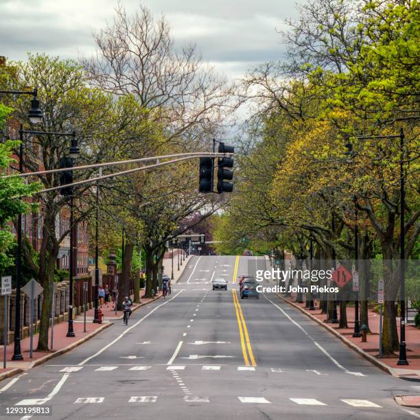 john f. kennedy street in harvard square, cambridge is empty during the early days of the covid-19 pandemic - cambridge street stock pictures, royalty-free photos & images