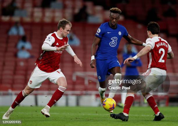 Tammy Abraham of Chelsea is challenged by Rob Holding of Arsenal and Hector Bellerin of Arsenal during the Premier League match between Arsenal and...