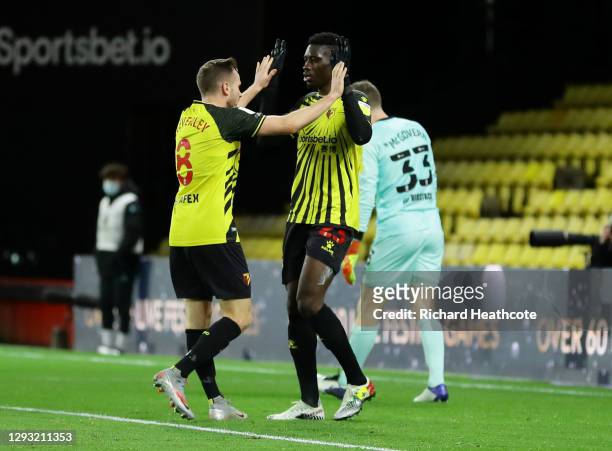 Ismaila Sarr of Watford celebrates with teammate Tom Cleverley after scoring his team's first goal during the Sky Bet Championship match between...