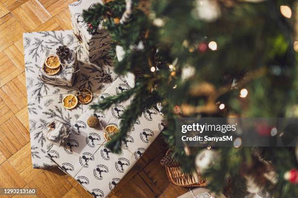 christmas gift at home - christmas presents under tree stock pictures, royalty-free photos & images