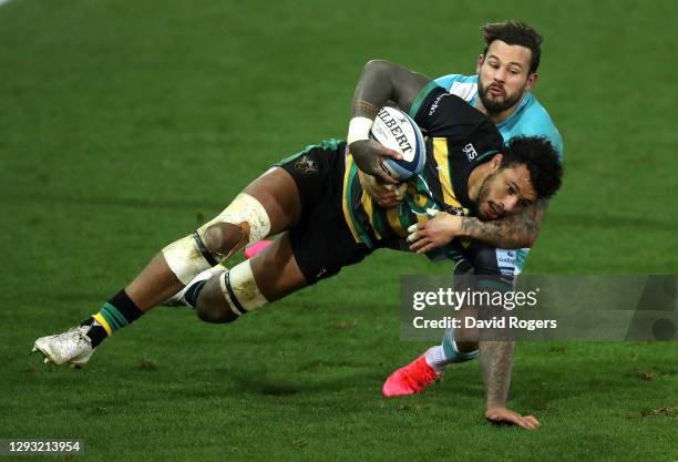 Courtney Lawes of Northampton Saints is tackled by Francois Hougaard during the Gallagher Premiership Rugby match between Northampton Saints and...