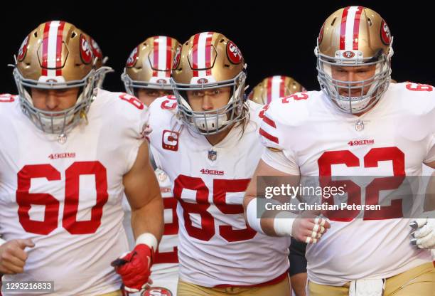 Offensive tackle Daniel Brunskill, tight end George Kittle, and center Tony Bergstrom of the San Francisco 49ers take the field during warmups before...