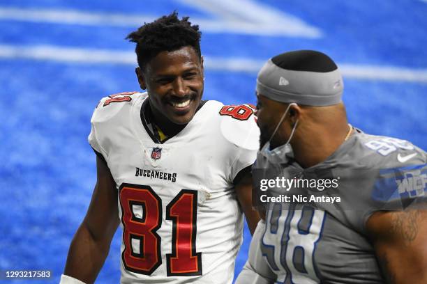 Antonio Brown of the Tampa Bay Buccaneers speaks with Everson Griffen of the Detroit Lions following a game at Ford Field on December 26, 2020 in...