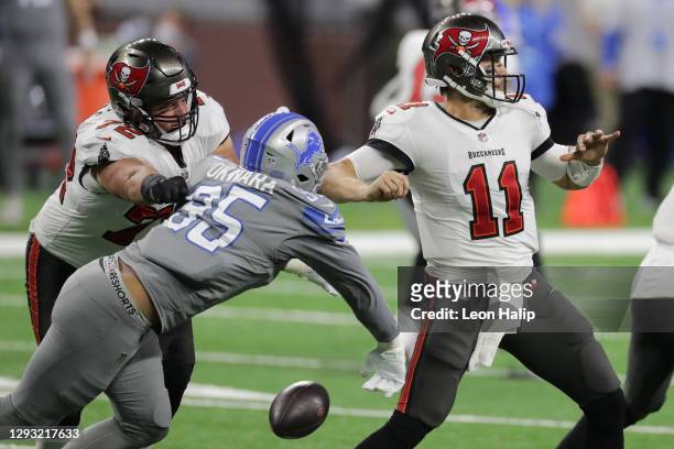 Romeo Okwara of the Detroit Lions strips the ball from Blaine Gabbert of the Tampa Bay Buccaneers during the fourth quarter of a game at Ford Field...