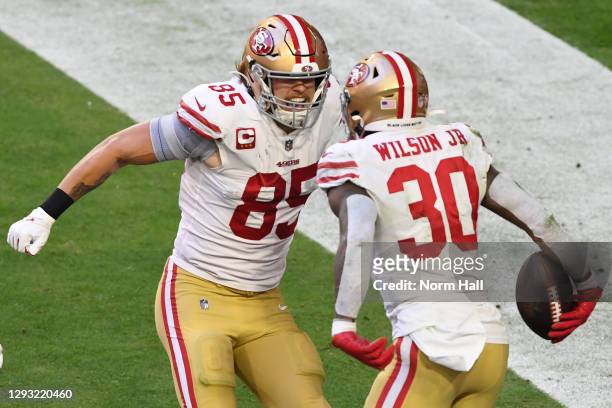 Running back Jeff Wilson Jr. #30 celebrates with tight end George Kittle of the San Francisco 49ers after Wilson's touchdown during the first half...