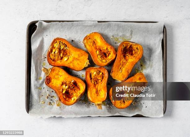 tray of roasted butternut squash on white background - winter squash stock pictures, royalty-free photos & images