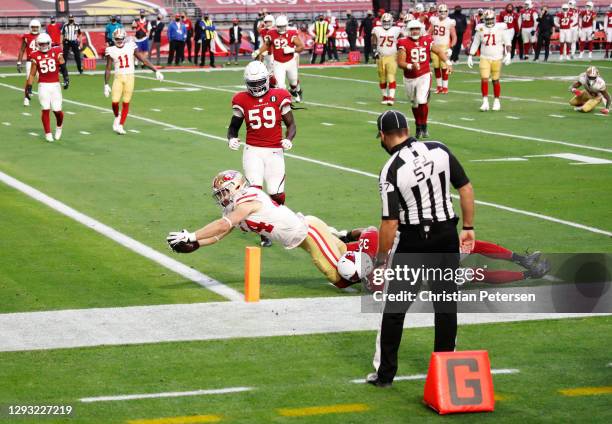 Fullback Kyle Juszczyk of the San Francisco 49ers scores a touchdown as safety Budda Baker of the Arizona Cardinals defends during the second half at...