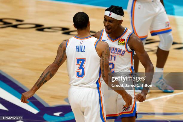 George Hill of the Oklahoma City Thunder celebrates with teammate Shai Gilgeous-Alexander following a three point basket by Hill during the fourth...