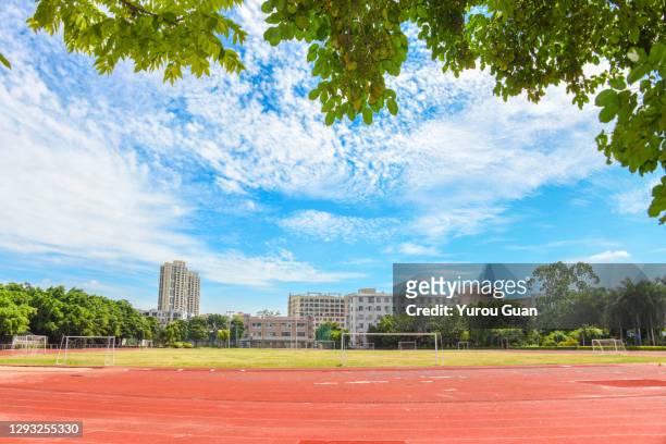 athletic track in the playground of the school. - all weather running track stock pictures, royalty-free photos & images
