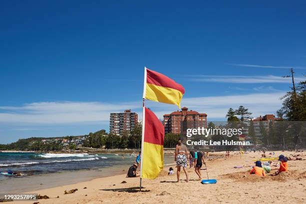 Beach flags are seen raised in Manly on December 27, 2020 in Sydney, Australia. Following clarification of the public health orders, patrolled...