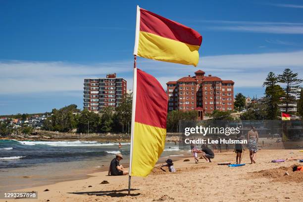 Beach flags are seen raised in Manly on December 27, 2020 in Sydney, Australia. Following clarification of the public health orders, patrolled...