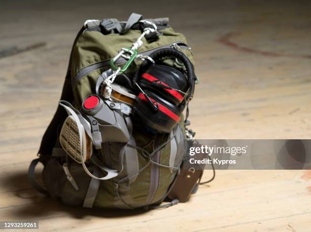 travel bag for hand luggage only flight during covid-19 epidemic - medical biohazard face mask, hearing defenders, camera case - camera bag stock-fotos und bilder