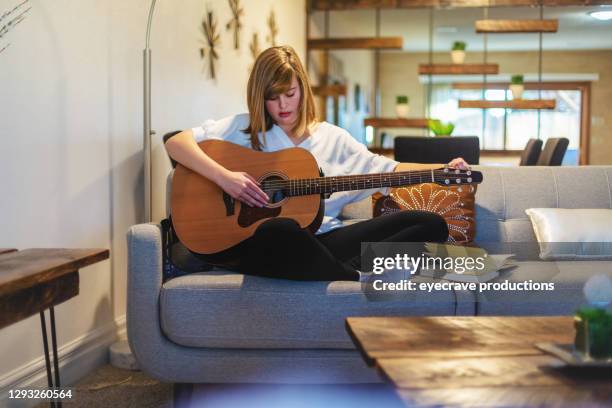 happy generation z female with guitar writing music photo series - song writer stock pictures, royalty-free photos & images