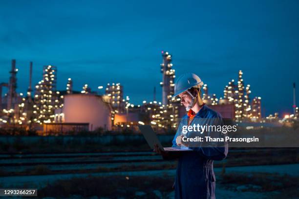 engineer checks shipment of chemicals at oil and gas industry pipeline job site - chemische stof stockfoto's en -beelden